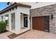 Inviting front entrance featuring a stone accent wall and wood garage door at 4509 Patricia Ann Ct, Orlando, FL 32839