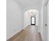 Bright hallway features an archway with wood flooring and a modern light fixture at 4509 Patricia Ann Ct, Orlando, FL 32839