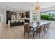 Bright, open kitchen and dining area featuring modern lighting fixtures and sleek design at 4509 Patricia Ann Ct, Orlando, FL 32839