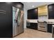 Modern kitchen with stainless steel refrigerator, black cabinets, and state-of-the-art ZLINE range at 4509 Patricia Ann Ct, Orlando, FL 32839