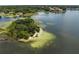 Breathtaking aerial view of the tranquil lake featuring a verdant island and picturesque surroundings at 4509 Patricia Ann Ct, Orlando, FL 32839
