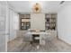 This bright home office has a large desk, a custom shelving, and a modern light fixture at 4509 Patricia Ann Ct, Orlando, FL 32839