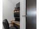 A compact home office space with a desk, chair, monitor, and shelving at 4509 Patricia Ann Ct, Orlando, FL 32839
