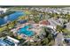 Aerial view showcasing the community pool and recreational area by a lake, perfect for relaxation and entertainment at 4918 Windermere Ave, Kissimmee, FL 34746