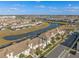 Expansive aerial view showcasing a community with multiple townhomes, lakes, and green spaces at 4918 Windermere Ave, Kissimmee, FL 34746