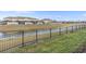 Scenic backyard featuring a pond view and a black metal fence, perfect for relaxation and outdoor enjoyment at 4918 Windermere Ave, Kissimmee, FL 34746