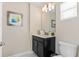 Bathroom with a dark-toned vanity, a framed mirror, and ample lighting, creating a refreshing and functional space at 4918 Windermere Ave, Kissimmee, FL 34746