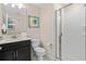 A well-lit bathroom with a sleek vanity, contemporary fixtures, and a glass-enclosed shower for a modern touch at 4918 Windermere Ave, Kissimmee, FL 34746