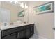 Bathroom with dual sinks, modern fixtures, and neutral finishes at 4918 Windermere Ave, Kissimmee, FL 34746
