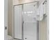 Clean bathroom featuring a glass-enclosed shower with white tiling and modern fixtures, paired with plush white towels at 4918 Windermere Ave, Kissimmee, FL 34746