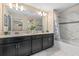 Modern bathroom featuring double vanity, neutral countertops, stylish white tile, and a tub with shower at 4918 Windermere Ave, Kissimmee, FL 34746
