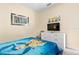 Cozy bedroom featuring a playful Minion-themed bedspread, a sleek dresser, and a modern wall-mounted television at 4918 Windermere Ave, Kissimmee, FL 34746