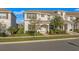 Charming two-story townhome with a well-maintained lawn, shrubbery, and a neatly paved walkway leading to the entrance at 4918 Windermere Ave, Kissimmee, FL 34746