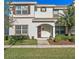 Charming two-story townhome with a well-maintained lawn, features a covered entryway, creating curb appeal at 4918 Windermere Ave, Kissimmee, FL 34746