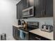 Well-equipped kitchen featuring stainless steel appliances and sleek black cabinets, blending style and functionality at 4918 Windermere Ave, Kissimmee, FL 34746
