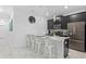 Modern kitchen with a breakfast bar and stainless steel appliances, perfect for cooking and entertaining at 4918 Windermere Ave, Kissimmee, FL 34746