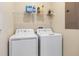 Functional laundry room with washer, dryer, and overhead storage, designed for convenience at 4918 Windermere Ave, Kissimmee, FL 34746