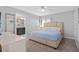 Comfortable main bedroom showcasing a plush bed, ample natural light, and an ensuite bathroom at 4918 Windermere Ave, Kissimmee, FL 34746