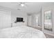 Comfortable main bedroom featuring carpet flooring, dresser, and a view of the ensuite bathroom at 4918 Windermere Ave, Kissimmee, FL 34746