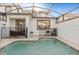 Inviting screened-in pool area with seating and BBQ grill at 4918 Windermere Ave, Kissimmee, FL 34746