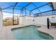 Screened-in pool with clear water, surrounded by a tiled patio area and safety fencing at 4918 Windermere Ave, Kissimmee, FL 34746