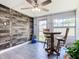 Cozy dining area featuring a wood accent wall and a ceiling fan for comfortable meals at 5050 Howison Rd, Kissimmee, FL 34746