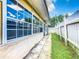 Home exterior featuring a narrow outdoor hallway along the side of the house and a white picket fence at 5050 Howison Rd, Kissimmee, FL 34746