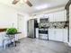 Updated kitchen featuring stainless steel appliances, white cabinetry, and attractive tile backsplash at 5050 Howison Rd, Kissimmee, FL 34746