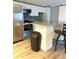 Well-lit kitchen featuring stainless steel appliances, white cabinets, and a small island at 5050 Howison Rd, Kissimmee, FL 34746
