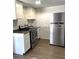 Modern kitchen featuring white cabinets, stainless steel appliances, and granite countertops at 5050 Howison Rd, Kissimmee, FL 34746