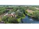 Beautiful aerial view of the apartment complex with a pond and fountain surrounded by trees at 5283 Images Cir # 308, Kissimmee, FL 34746
