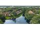 Scenic aerial view of the apartment complex surrounded by lush greenery and a tranquil lake at 5283 Images Cir # 308, Kissimmee, FL 34746