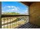 Balcony with lake views, metal railing and wooden deck to relax and enjoy the beautiful outdoors at 5283 Images Cir # 308, Kissimmee, FL 34746