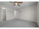 Spacious bedroom features neutral walls and ceiling fan, with an en-suite bathroom and ample closet space at 5283 Images Cir # 308, Kissimmee, FL 34746