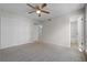 Spacious bedroom featuring a ceiling fan, double closet doors, and easy access to a bathroom at 5283 Images Cir # 308, Kissimmee, FL 34746