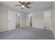 Cozy bedroom featuring new carpet, ceiling fan, closet and access to full bathroom at 5283 Images Cir # 308, Kissimmee, FL 34746