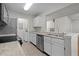 Efficient kitchen featuring white cabinets, stainless steel appliances, and durable tile flooring at 5283 Images Cir # 308, Kissimmee, FL 34746