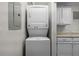 Efficient laundry area with a stacked washer and dryer, cabinets, and utility connections, offering convenience at 5283 Images Cir # 308, Kissimmee, FL 34746