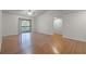 Spacious living room features wood floors, ceiling fan, and sliding door to balcony at 5283 Images Cir # 308, Kissimmee, FL 34746