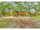 Community playground nestled among mature trees, providing a fun and safe play area for children at 5283 Images Cir # 308, Kissimmee, FL 34746