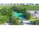 Aerial view of well-maintained tennis courts surrounded by lush trees and convenient parking at 5283 Images Cir # 308, Kissimmee, FL 34746