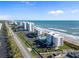 Aerial view of beachfront condos with pool, parking, and easy beach access at 5301 S Atlantic Ave # 51, New Smyrna Beach, FL 32169