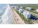 Beautiful aerial view of beachfront condos, landscaping, and ocean waves at 5301 S Atlantic Ave # 51, New Smyrna Beach, FL 32169