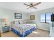 Comfortable bedroom with a ceiling fan, artwork, and large window offering a view of the ocean at 5301 S Atlantic Ave # 51, New Smyrna Beach, FL 32169