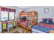 Comfortable bedroom with bunk beds, a desk, and nautical-themed decor at 5301 S Atlantic Ave # 51, New Smyrna Beach, FL 32169