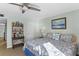 Inviting bedroom featuring a ceiling fan, artwork, and coastal decor at 5301 S Atlantic Ave # 51, New Smyrna Beach, FL 32169