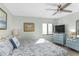 Bedroom featuring a ceiling fan, artwork, and large window that allows natural light at 5301 S Atlantic Ave # 51, New Smyrna Beach, FL 32169