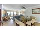 Open-concept dining area connected to living room with ocean view and balcony access at 5301 S Atlantic Ave # 51, New Smyrna Beach, FL 32169