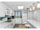Bright kitchen with white cabinets, modern appliances, and backsplash with breakfast bar at 5301 S Atlantic Ave # 51, New Smyrna Beach, FL 32169