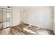 A bedroom has vinyl floors, mirror closet doors and a window to allow in natural light at 5321 Vineland Rd # 101, Orlando, FL 32811